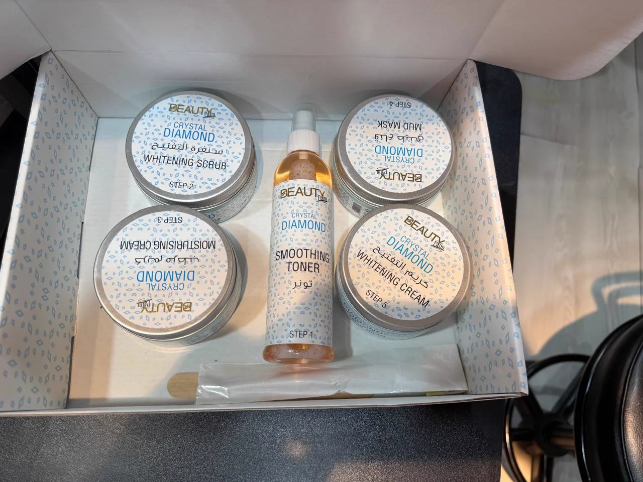 Overhead flatlay of Beauty Palm Crystal Diamond facial kit in box with applicator